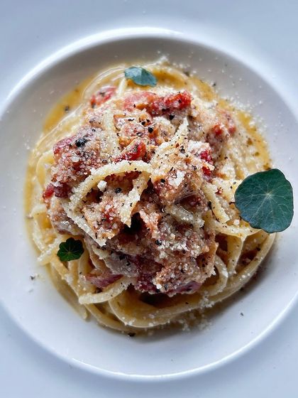 My interpretation of a classic Carbonara. I use high-quality spaghetti, pecorino romano, guanciale, and fresh Tellicherry pepper for an authentic and rich flavor.