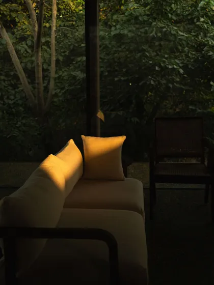 A single beam of winter sun cuts through the lounge, highlighting a pillow and reminding us of the beauty in fleeting moments.