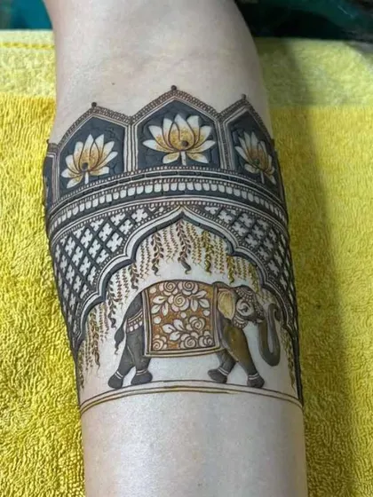 I love creating unique armband designs. This piece features a majestic elephant under a traditional archway, surrounded by lotus flowers, all done with my organic henna.