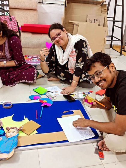 Volunteers smiling as they work on craft projects. Our sessions are always filled with laughter, conversation, and a shared sense of purpose.