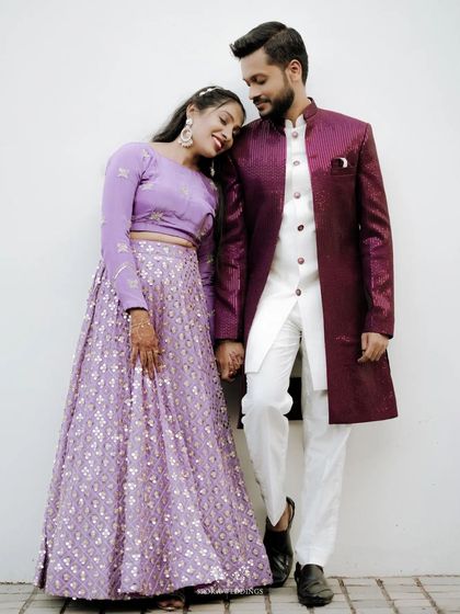 A sweet moment between the couple, the bride resting her head on the groom's shoulder, both dressed elegantly for their reception.
