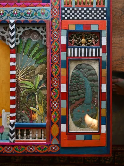 Another detail of the finished panel, showing the intricate layers of painting, decoupage, and architectural elements. Every inch of the panel is filled with color and story.