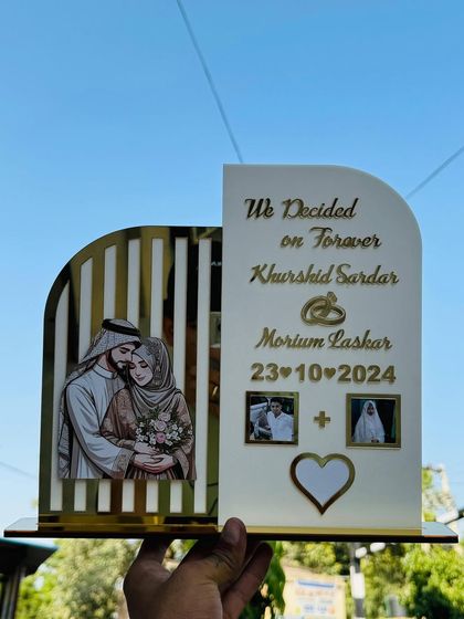 This is my trending customized thumb frame. It's a modern design where I can add your names, a special date, and photos, creating a unique and stylish display piece.