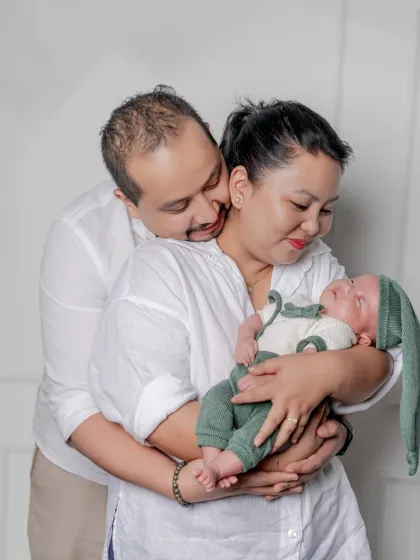 A quiet moment of love and adoration. I aim to capture the candid, loving glances between new parents as they embrace their baby and each other.