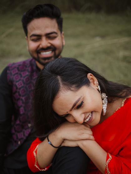 The sound of shared laughter is our favorite melody. This candid moment from Tulsi and Mohit's outdoor pre-wedding shoot shows the pure joy they find in each other's company.