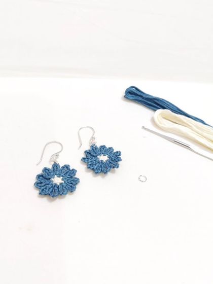 Dainty and elegant micro-crochet flower earrings in a beautiful shade of teal with a cream center.
