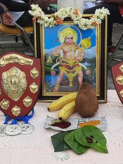 Before every competition, we seek blessings for strength and focus. This setup shows the shields and medals next to a traditional pooja, blending culture with competitive spirit.