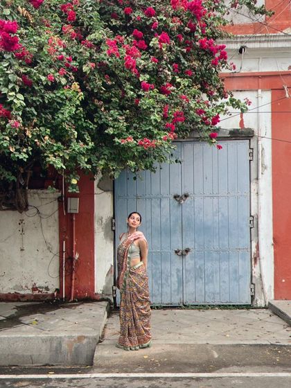 Posing against a charming, colorful doorway in French Pondicherry. I am available for travel and have experience shooting in various cities to match a brand's specific creative vision.