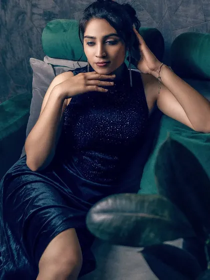 A close-up portrait allows me to focus on expression and detail. The soft lighting on the model's face, combined with the dark, textured background, creates a feeling of intimacy and elegance, making it a powerful shot for a beauty or fashion feature.
