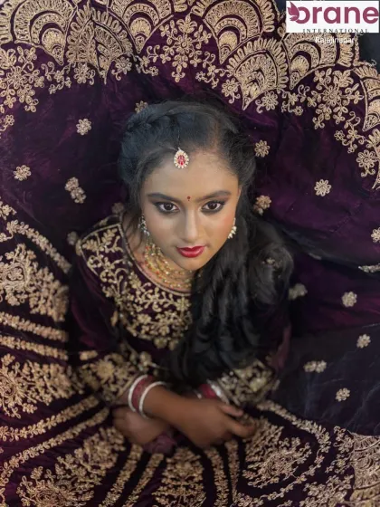 An artistic top-angle shot that beautifully displays the intricate embroidery of the velvet lehenga.