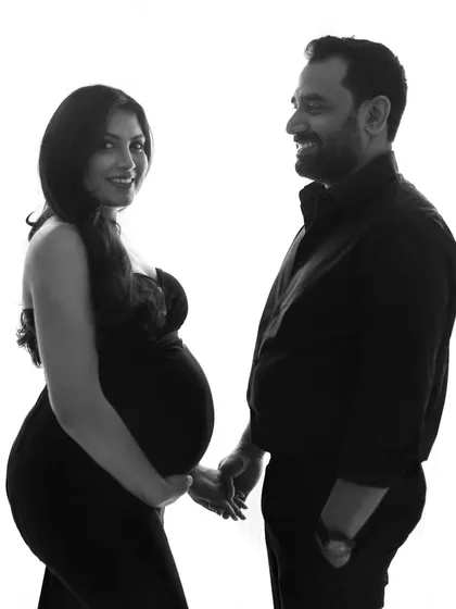 A lovely black and white silhouette of the couple holding hands. This image beautifully captures their connection and shared excitement in a simple, modern, and artistic way.