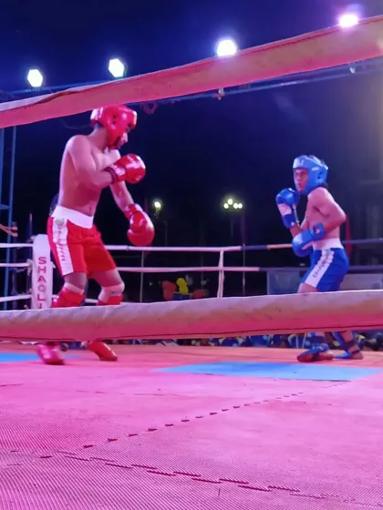 The fighters touch gloves before the start of the semi-final match.