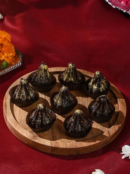 For a modern twist on a traditional favourite, I offer these rich chocolate modaks dusted with gold. They are a refined offering worthy of Lord Ganesha’s blessings.