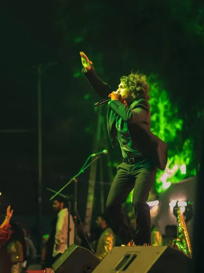 Another high-energy shot of our vocalist commanding the stage at a public Christmas dance.