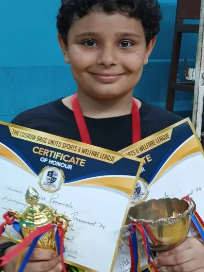 Narios Poonawala with his U12 Boys Singles trophy and a special award for being the Upcoming Player of the Tournament.