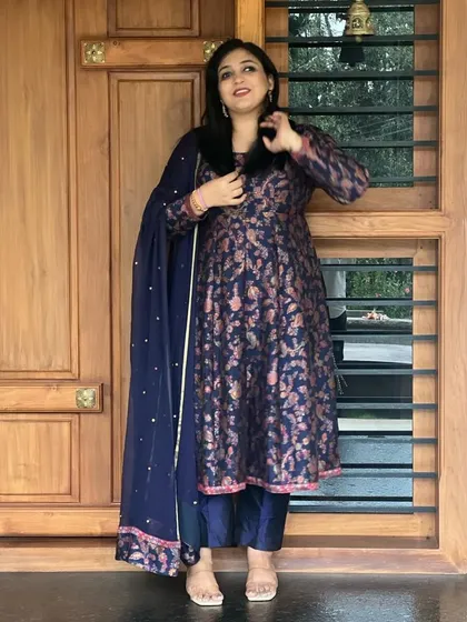 Nothing brings more joy than designing for a best friend. Shivanthi wears a custom-stitched anarkali suit in navy blue brocade with a matching embroidered dupatta.