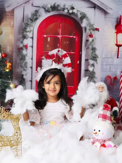A full view of the magical Christmas setup for an older child, complete with a decorated tree and a snowy landscape.