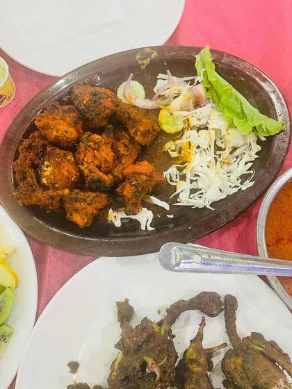 Our Double Dum Chicken, a rich and flavorful dish, served alongside other delicacies.