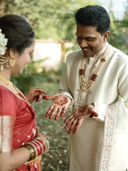A playful moment where the bride shows off her henna to the groom. His delighted reaction is a perfect example of the candid joy we love to capture.