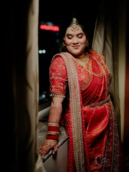 A stunning portrait of the bride by the window, the city lights creating a beautiful bokeh effect.