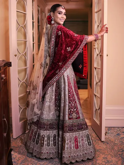 A playful, over-the-shoulder glance from the bride, showing her happiness and the beautiful back details of her outfit.