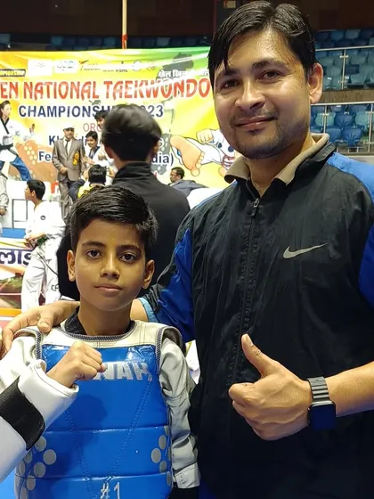 A young student in his sparring gear, ready for his match.