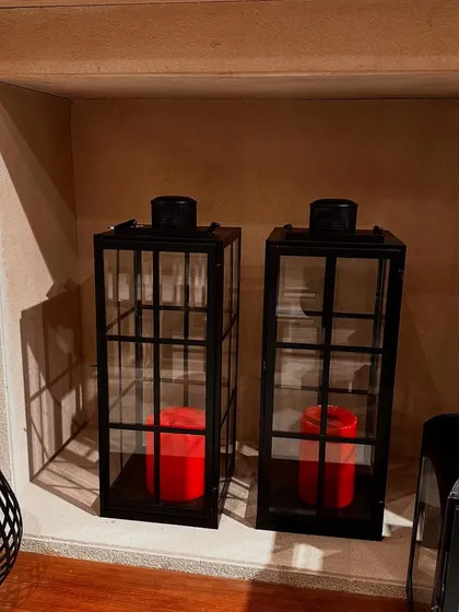 My black metal lanterns are a great way to add a modern yet cozy feel to your decor. Here they are styled in a niche with bright red candles for a pop of color.