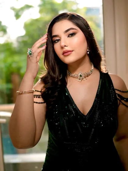 This pose highlights the bride's stunning emerald ring and the delicate details of her makeup. The soft glam look ensures she looks polished and put-together from every angle.