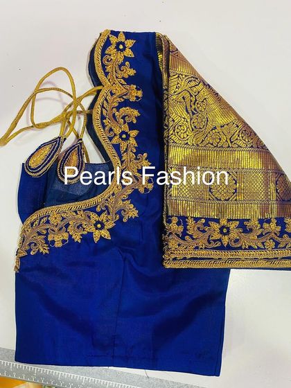 For this royal blue silk blouse, I used gold Zari to create a bold floral vine pattern. The design flows from the back to the front, and the sleeves have a traditional pattu border.