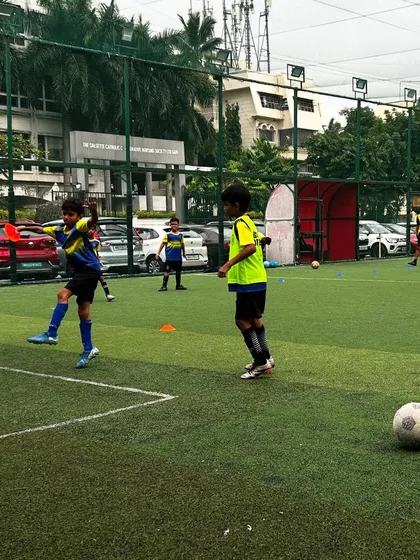 A player practices his first touch during a passing drill on the turf.