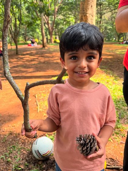 Nature's toys are the best toys. This little boy proudly holds a pinecone and a twig, treasures he found during our nature hunt. These simple objects spark so much more imagination than plastic toys.