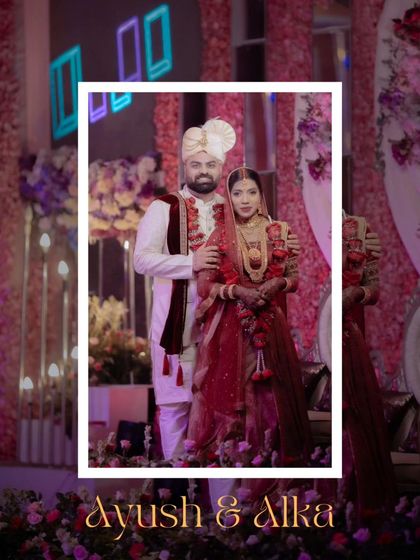 A classic wedding portrait of Ayush and Alka, their traditional attire and the grand floral decor creating a picture of timeless elegance.