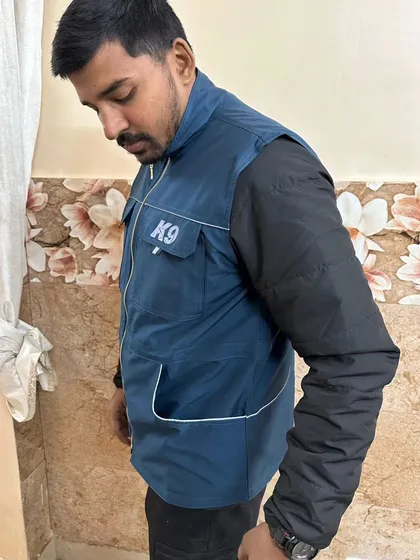 A side view of the blue K9 trainer vest, showing the clean lines and the placement of the front hand pockets. The material is tough enough for daily use but light enough that you'll barely notice you're wearing it.
