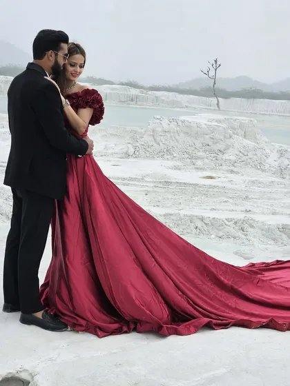 A romantic couple's shot featuring our dramatic red trail gown. This is the kind of image that sells a pre-wedding photography package, and our gown is the centerpiece.