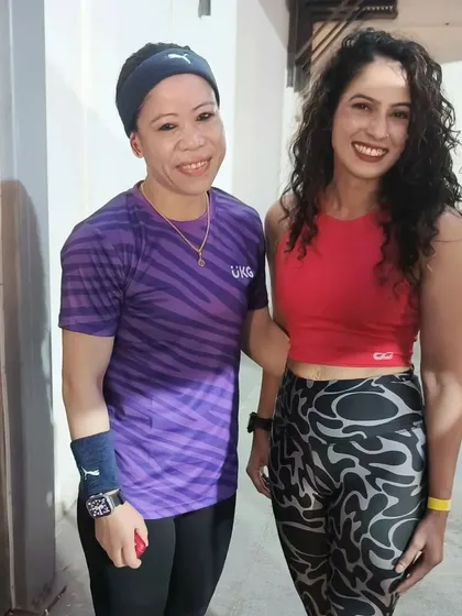 A participant gets a photo with Mary Kom. I facilitate these interactions to maximize the value and memorability of the event for every attendee.