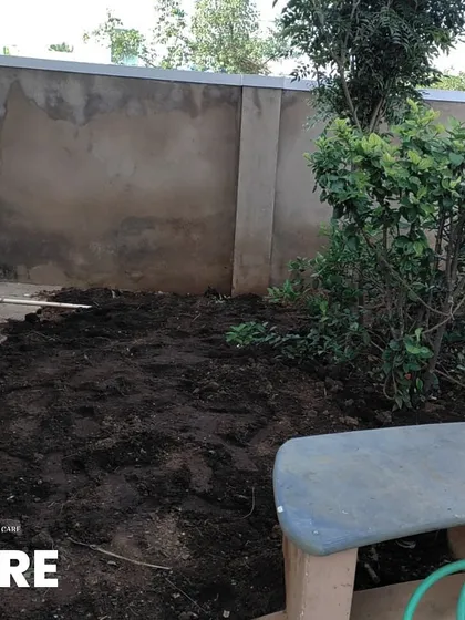 Before: A small, unused corner of a property with bare soil and an unfinished wall, waiting for a purpose.