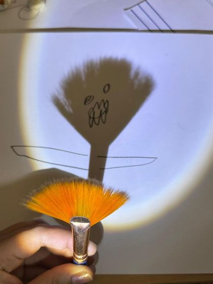 In our emergent literacy workshop, children explore light and shadow. By tracing the shadows of objects, they develop fine motor control and visual thinking, turning a science concept into a pre-writing and storytelling activity.