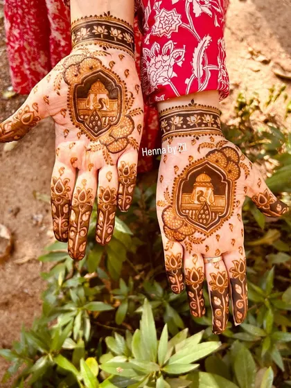 A closer look at the Shreenathji portrait on my palms. The design is framed beautifully, making the deity the central focus of the artwork.