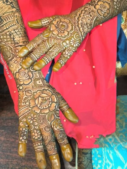 A look at the fresh henna paste for two different bridal designs, showing the precision of the application.