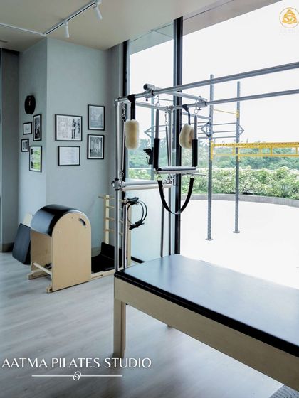 The studio space is designed to be open and full of natural light, with a view of the greenery outside. It features a range of equipment, including the Cadillac and Ladder Barrel, for a complete workout.