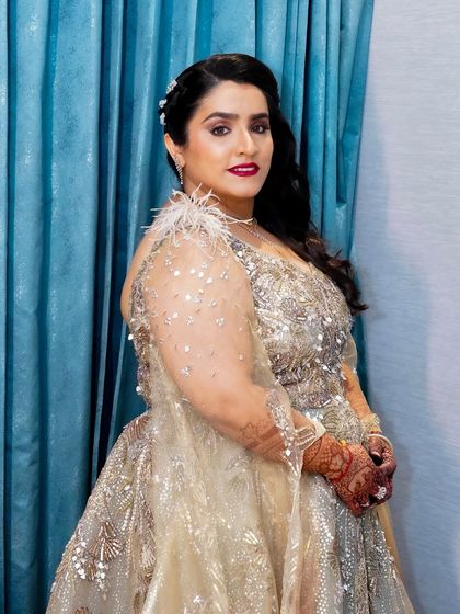 A side profile that shows off the glamorous side-swept hairstyle and the flawless application of her makeup. She looks every bit the star of the show.