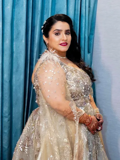 A side profile that shows off the glamorous side-swept hairstyle and the flawless application of her makeup. She looks every bit the star of the show.