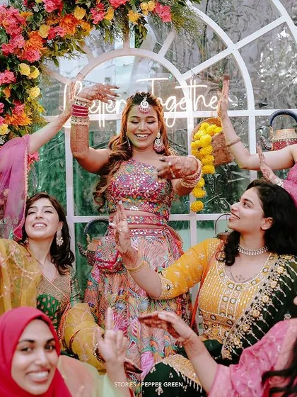 Pure celebration as Arya and her bridesmaids dance together. Capturing the energy and fun of pre-wedding events like the Sangeet is essential to a complete wedding story.