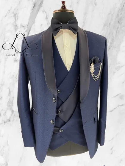 A well-dressed man makes the best impression. This classic navy blue three-piece suit with a shawl collar is a timeless addition to any wardrobe.