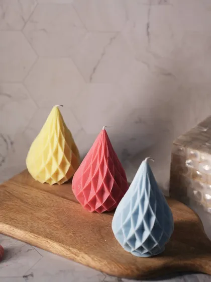 These teardrop-shaped pillar candles have a modern, geometric pattern and come in a variety of colors to match your decor.