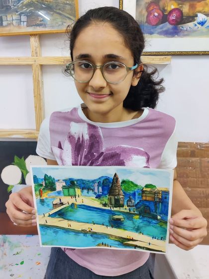 A lovely watercolor landscape of a riverside town, painted by one of our teen students. Our classes help students learn perspective and atmospheric effects.