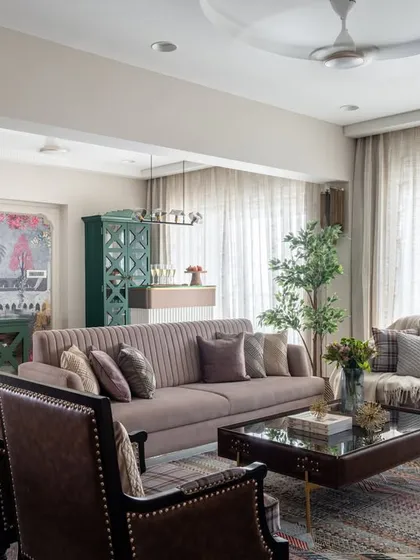 A beautiful fusion of classical and modern design. In this living room, we blended modern furniture and colors with the timeless elegance of brass details and intricate wall moldings.