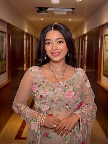 A beautiful smile to complete the look. The soft glam enhances her features, making her look fresh and camera-ready for the celebration.