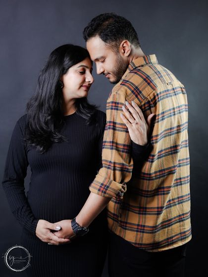 An artistic and intimate pose, with the couple's foreheads touching. This black and white style shot emphasizes emotion and connection.