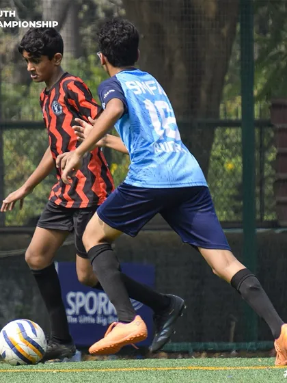Our player dribbles forward with speed and control, looking to break through the defense during a Youth Championship match.
